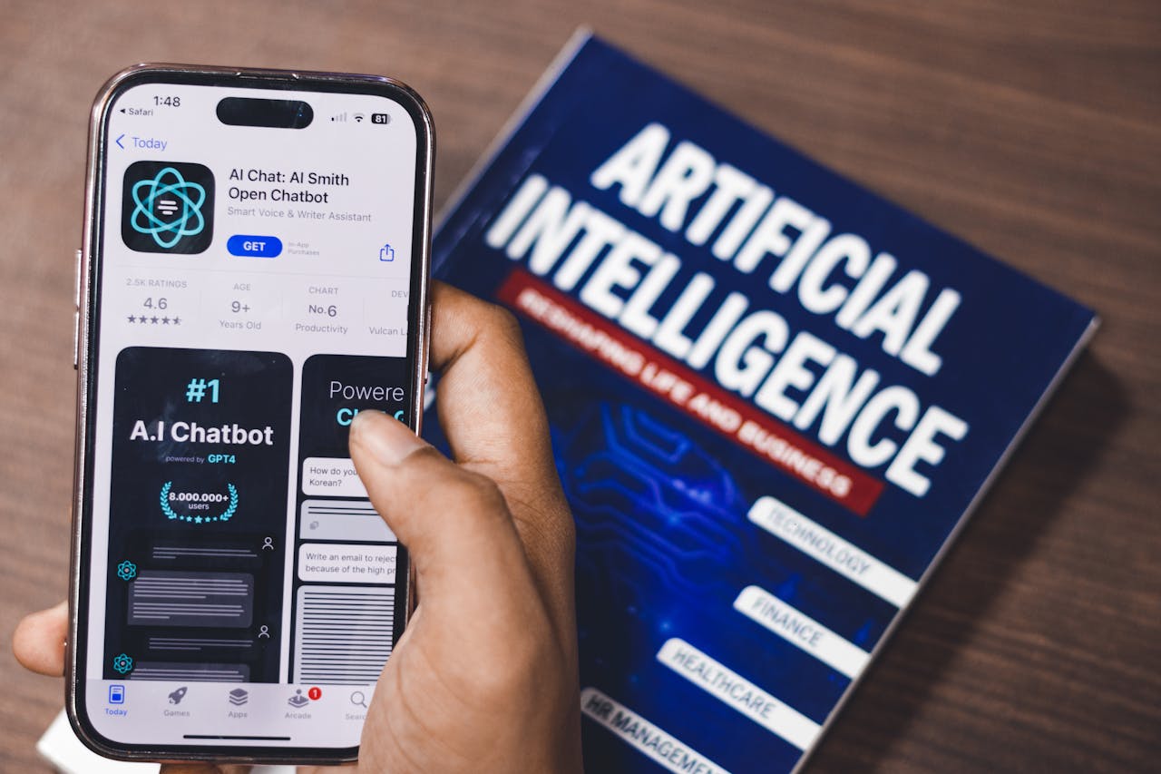 Crafting Captivating Headlines: Your awesome post title goes here Smartphone displaying AI app with book on AI technology in background.